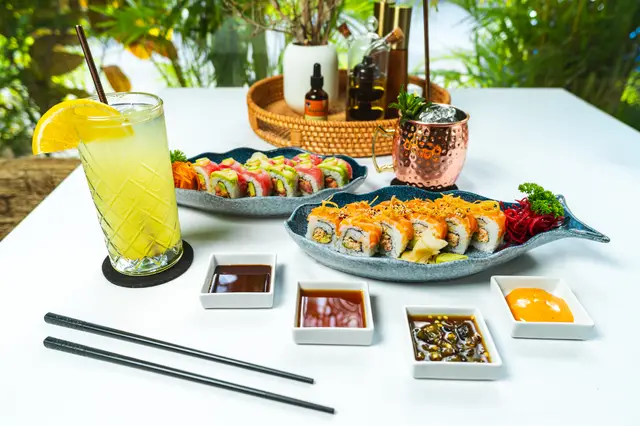Full table of signature sushi rolls with a moscow mule and citrus highball at MERO 18 Cancun