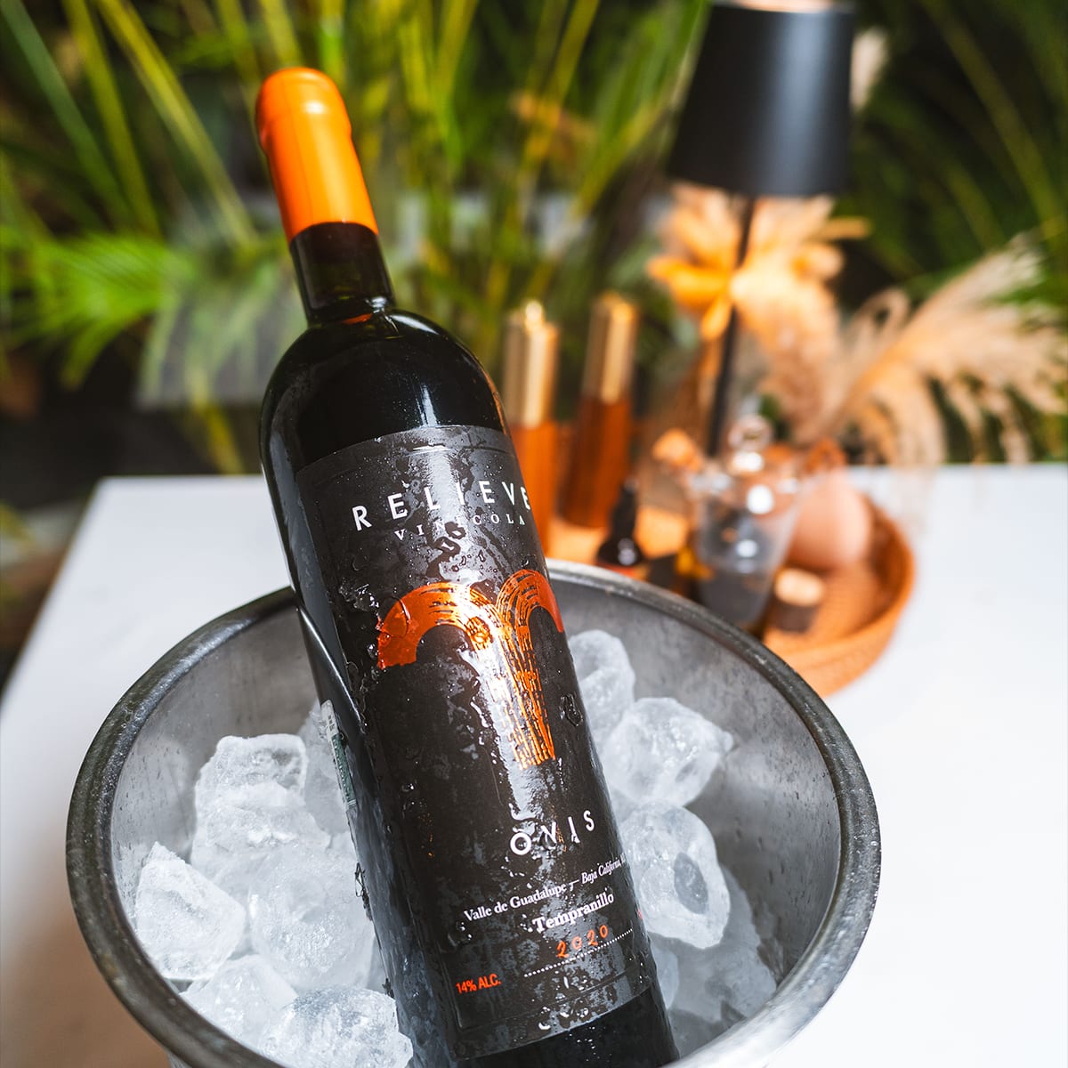 A bottle of Mexican red wine, Relieve Ovis Tempranillo from Valle de Guadalupe, chilling in an ice bucket at MERO 18