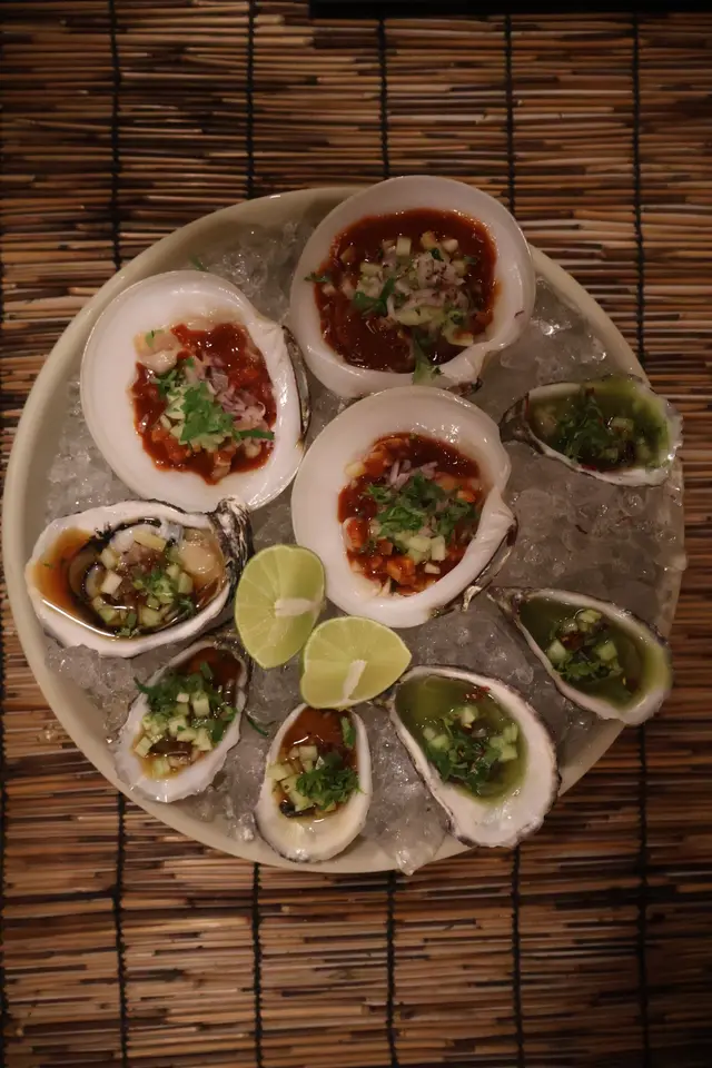 Fresh oysters and clams on ice, three preparations